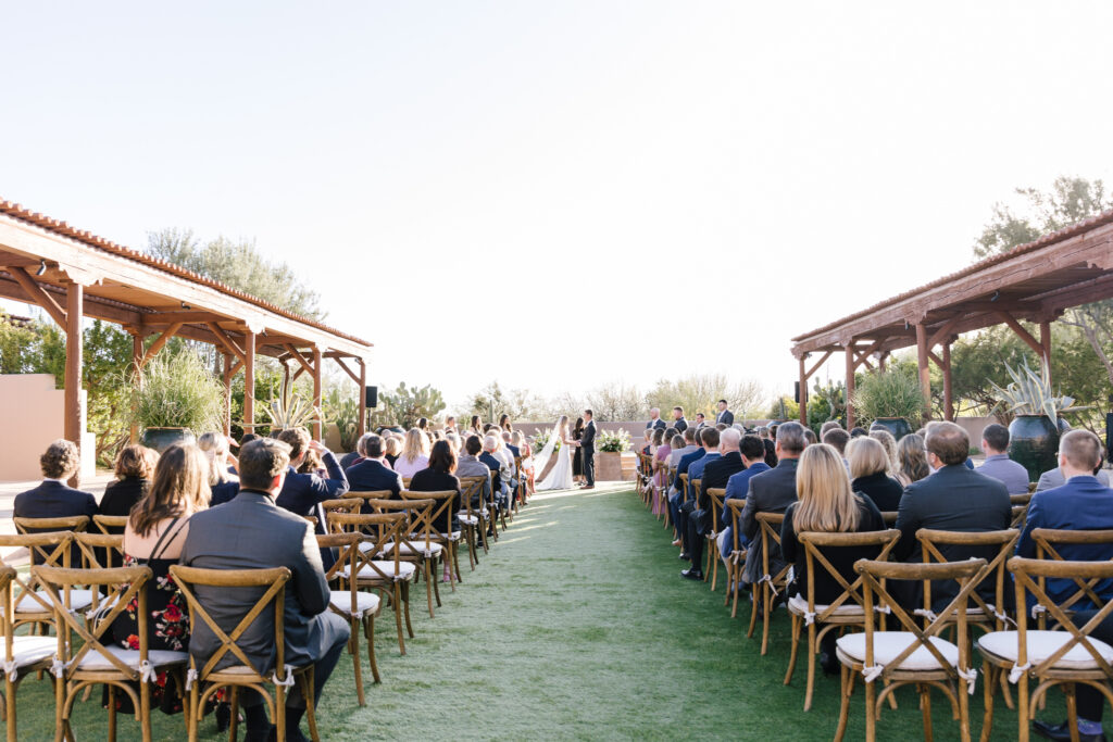 Bride and groom at the atlar during their outdoor wedding ceremony at the Four Seasons Scottsdale Resort at Troon North.