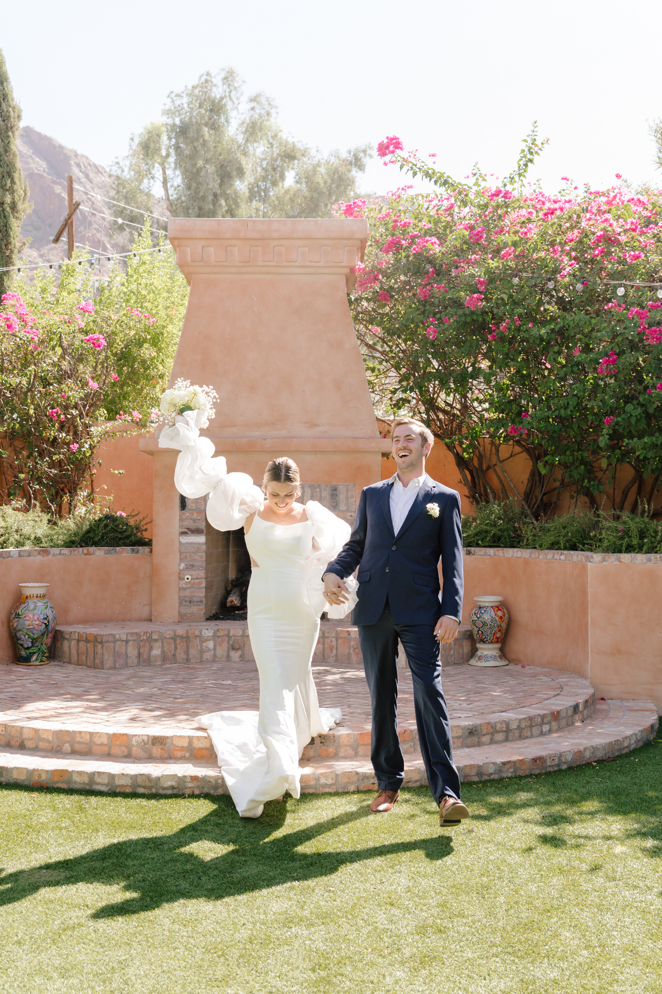 Bride and groom exiting wedding ceremony at one of the best Phoenix wedding venues, the Royal Palms Resort Scottsdale.