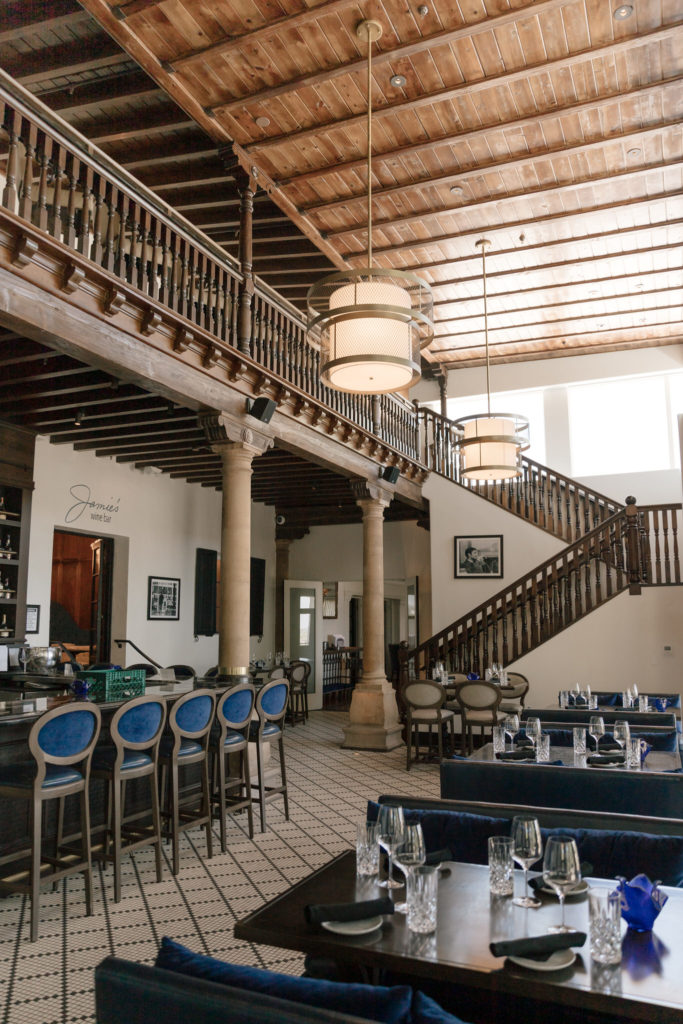 The Wrigley Mansion bar in Arizona featuring vintage blue velvet bar stools and historic architecture.